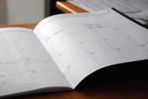 Agenda mensal aberta sobre mesa de madeira